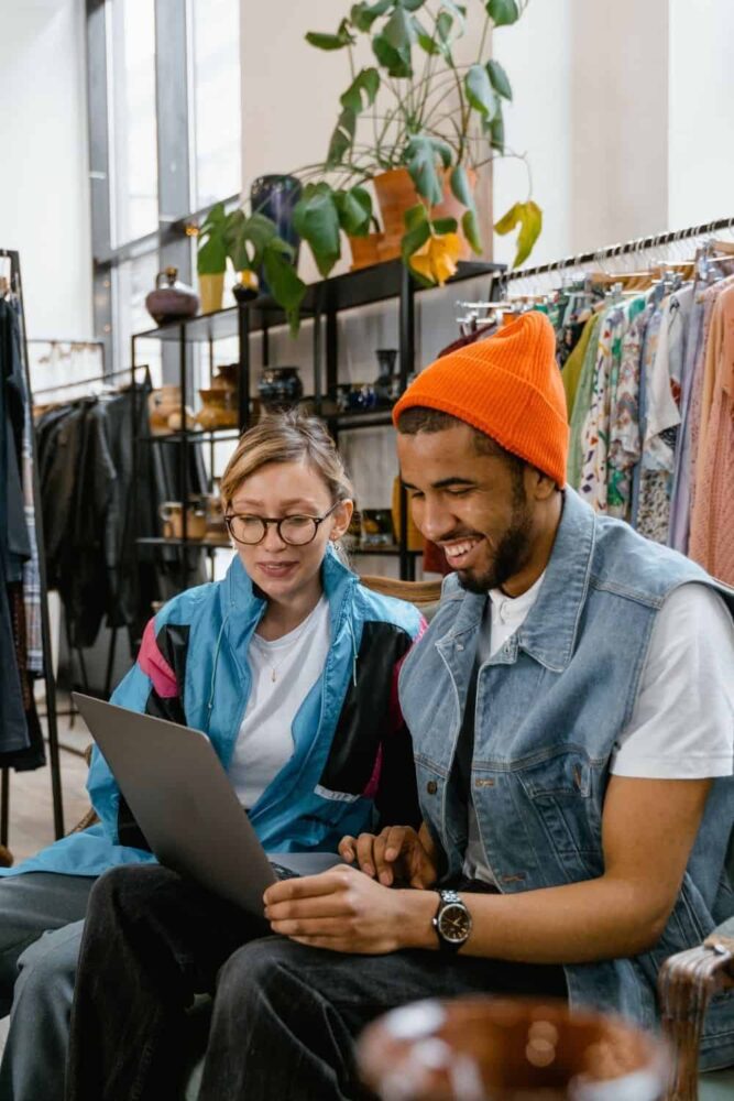 2 people viewing a laptop