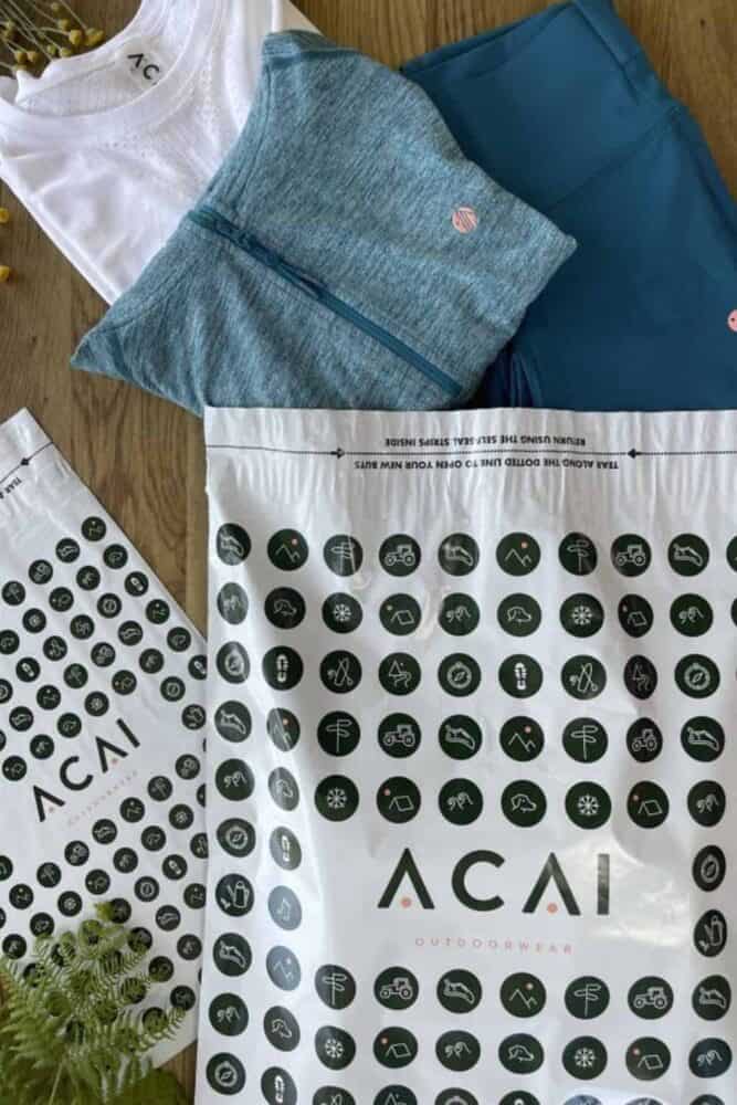 ACAI Outdoorwear Branded mailing bags manufactured by Duo Packaging with ACAI's products positioned coming out of the branded mailing bag.