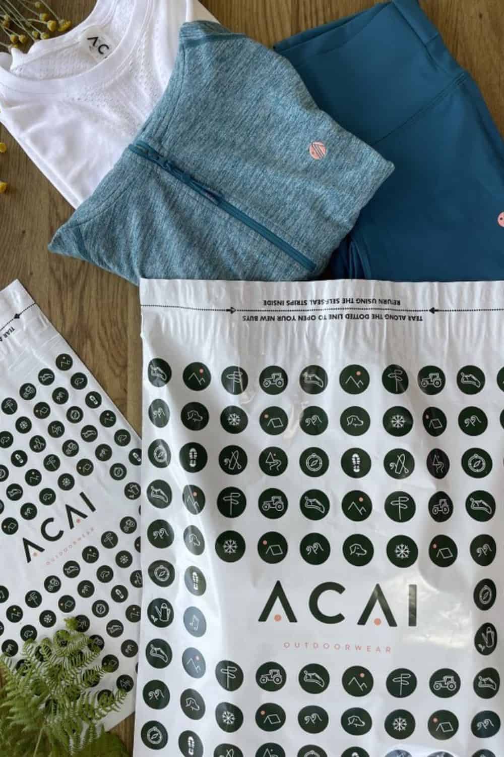ACAI Outdoorwear Branded mailing bags manufactured by Duo Packaging with ACAI's products positioned coming out of the branded mailing bag.